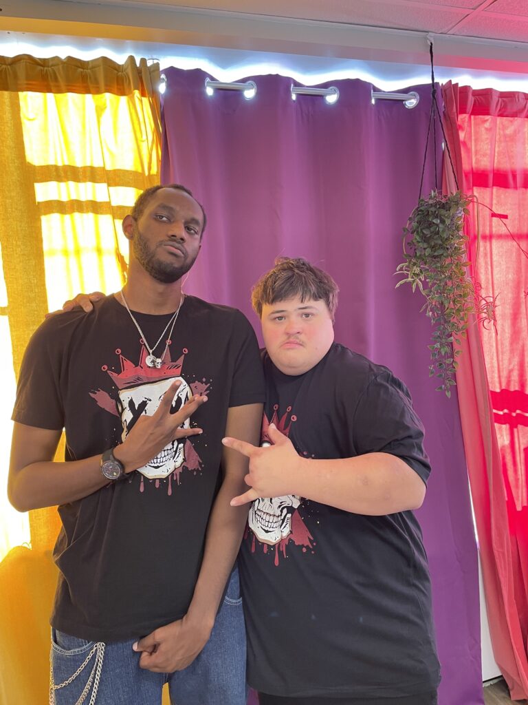 Two Adults in Motion members posing together in matching NoLimits t-shirts